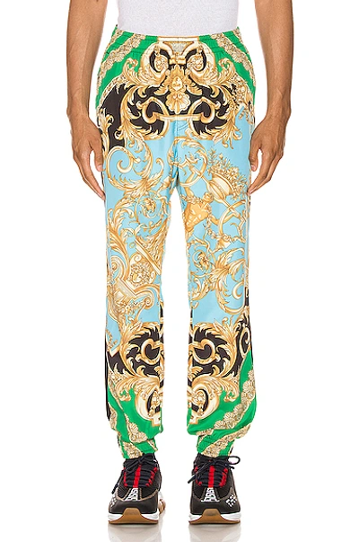 Shop Versace Print Pants In Green & Blue