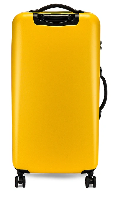 Shop Herschel Supply Co . Trade Large Suitcase In Yellow. In Nugget Gold