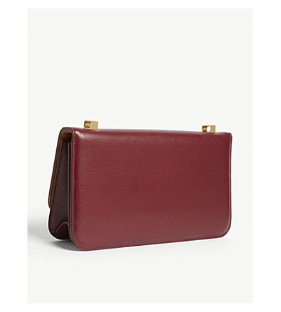 Shop Bottega Veneta Sphere Clasp Leather Cross-body Bag In Bordeaux/gold