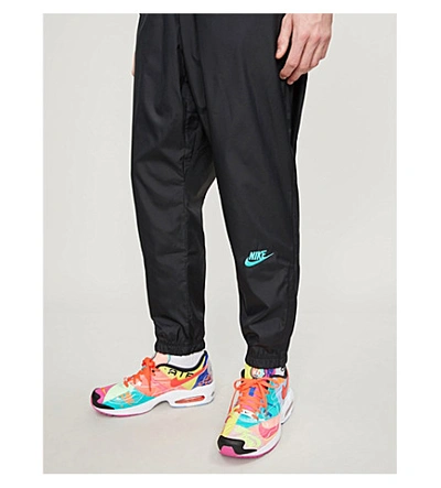 Shop Nike X Atmos Shell Trousers In Black/hyper Pink