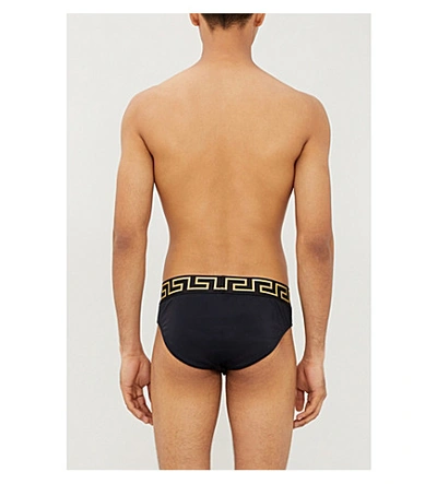 Shop Versace Iconic Low-rise Swim Briefs In Black Gold