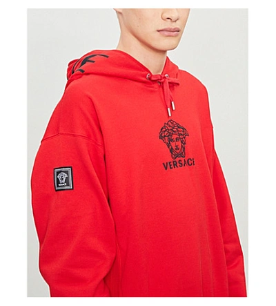 Shop Versace Logo-embroidered Cotton-jersey Hoody In Hot Red