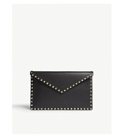 Shop Valentino Rockstud Grained Leather Envelope Clutch In Black