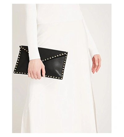 Shop Valentino Rockstud Grained Leather Envelope Clutch In Black