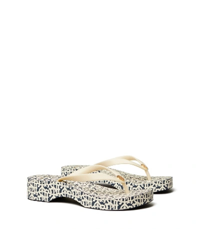 Shop Tory Burch Printed Carved Wedge Flip-flop In New Ivory/buddy Logo