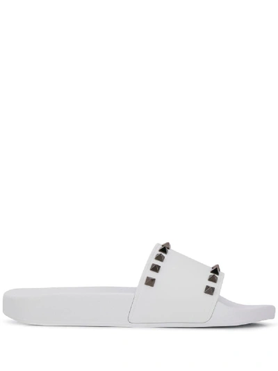 Shop Valentino Rockstud Slides In White