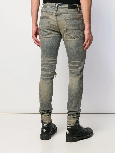 Shop Amiri Ripped Jeans In Blue