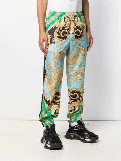 Shop Versace Printed Trousers In Green