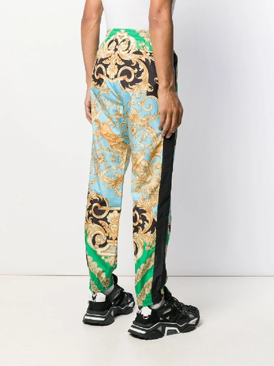 Shop Versace Printed Trousers In Green