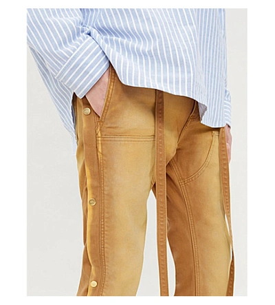 Shop Fear Of God Button-embellished Regular-fit Tapered Denim Trousers In Rust