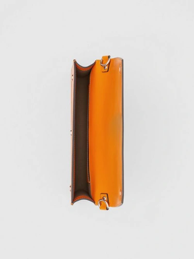 Shop Burberry Triple Stud Grainy Leather Crossbody Bag In Bright Orange