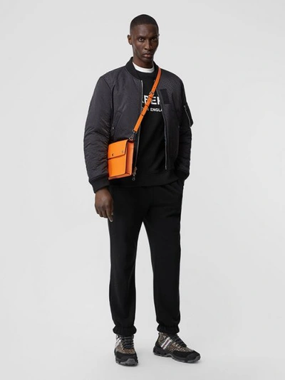 Shop Burberry Triple Stud Grainy Leather Crossbody Bag In Bright Orange