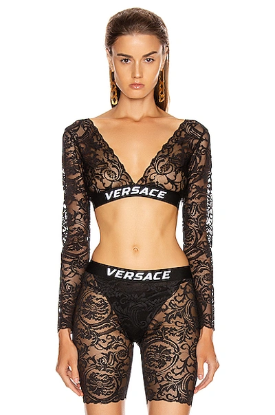 Shop Versace Lace Long Sleeve Crop Top In Black