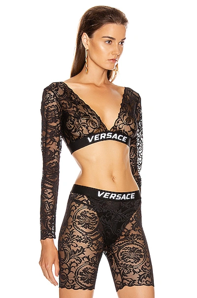 Shop Versace Lace Long Sleeve Crop Top In Black