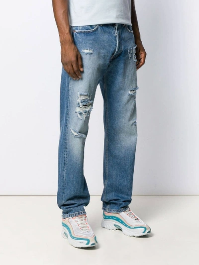 Shop Vetements Distressed Logo Jeans In Blue