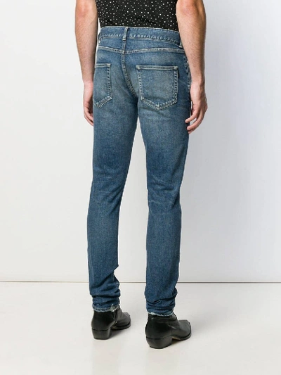 Shop Saint Laurent Faded Mid-rise Slim Jeans