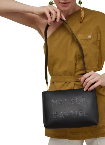 Shop Mansur Gavriel Vegetable-tanned Leather Slogan Crossbody Bag In Black/flamma