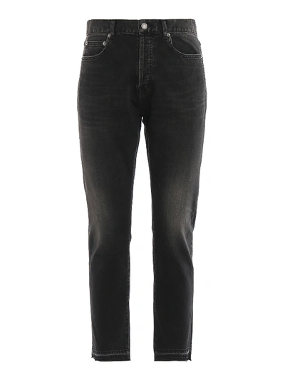 Shop Saint Laurent Faded Jeans With Raw Cut Hem In Black
