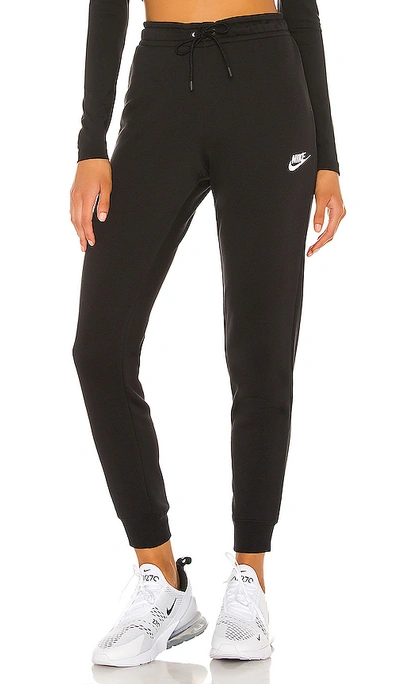 Shop Nike Nsw Essential Tight Fleece Pant In Black.