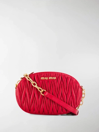 Shop Miu Miu Oval-shaped Matelassé Shoulder Bag In Red