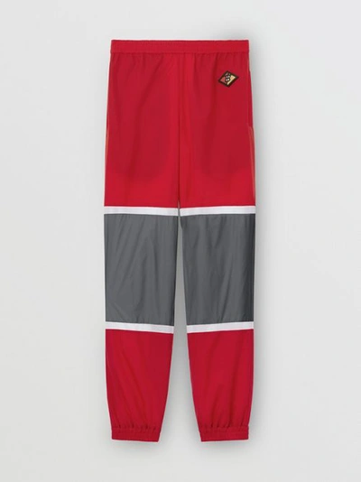 Shop Burberry Logo Graphic Striped Nylon Trackpants In Bright Red