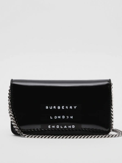 Shop Burberry Tape Print Laminated Phone Wallet With Strap In Black