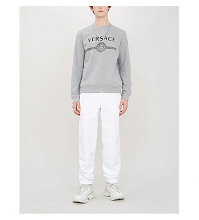 Shop Versace Branded Crewneck Cotton-jersey Sweatshirt In Grigio Chiaro