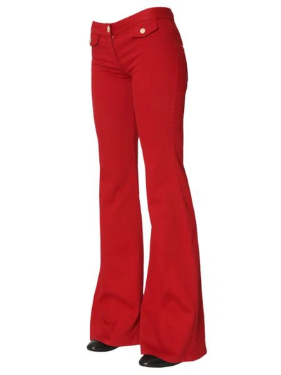 Shop Balmain Denim Stretch Flare Trousers In Red
