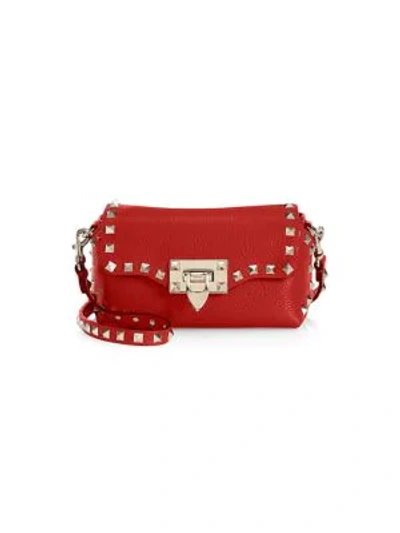 Shop Valentino Garavani Mini Rockstud Leather Crossbody Bag In Red