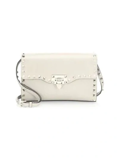 Shop Valentino Women's Small Rockstud Leather Crossbody Bag In Ivory