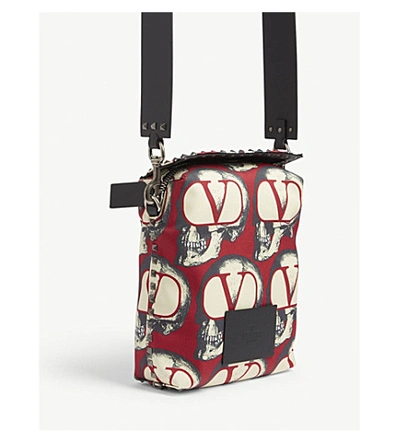 Shop Valentino X Undercover Skull-printed Canvas Messenger Bag In Red