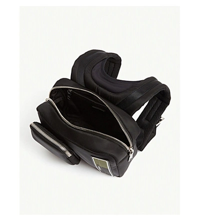 Shop Prada Rubberised-logo Shell Backpack In Black