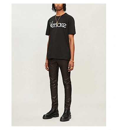 Shop Versace Logo Brand-embroidered Cotton T-shirt In Nero Bianco