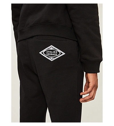Shop Versace Atelier Cotton-jersey Jogging Bottoms In Black
