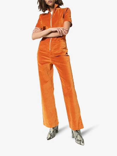 Shop Staud Zipped Velvet Jumpsuit In Orange