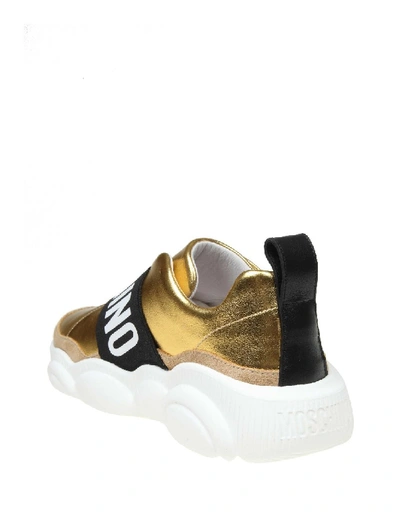 Shop Moschino Slip On Teddy Run In Gold Laminated Leather In White