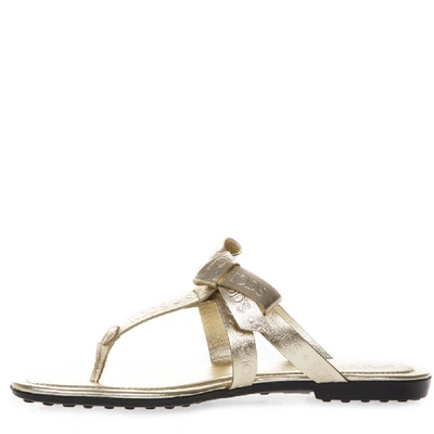 Shop Tod's Laminate Gold Leather Logo Flip Flop Sandal In Neutrals