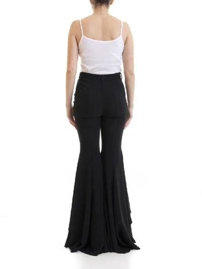 Shop Versace Flared Trousers In Black