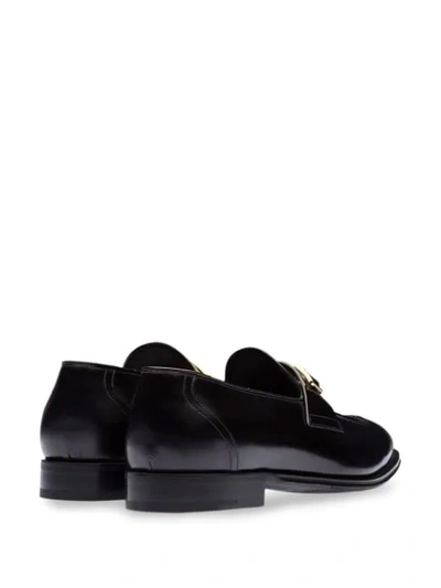 Shop Prada Logo Buckle Loafers In Black