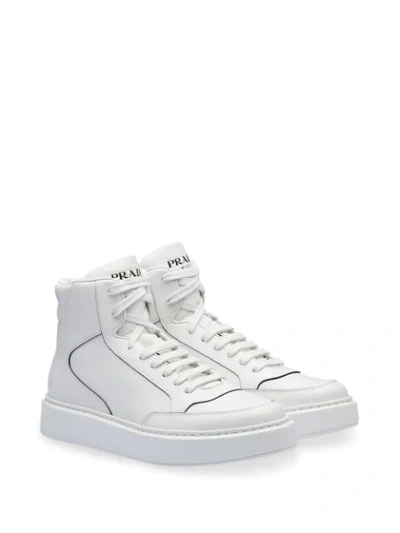 Shop Prada Embossed Logo Hi-top Sneakers In White