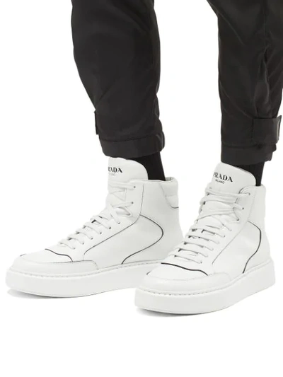 Shop Prada Embossed Logo Hi-top Sneakers In White