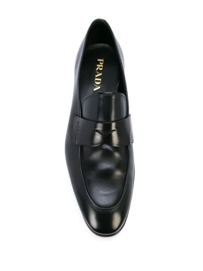 Shop Prada Logo Embossed Loafers In Black
