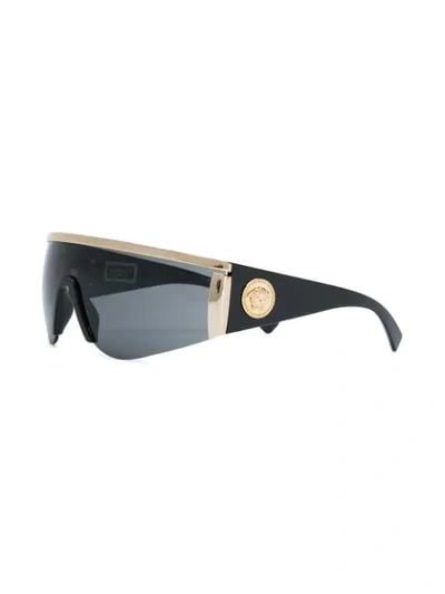 Shop Versace Tinted Visor Sunglasses In 1000/87