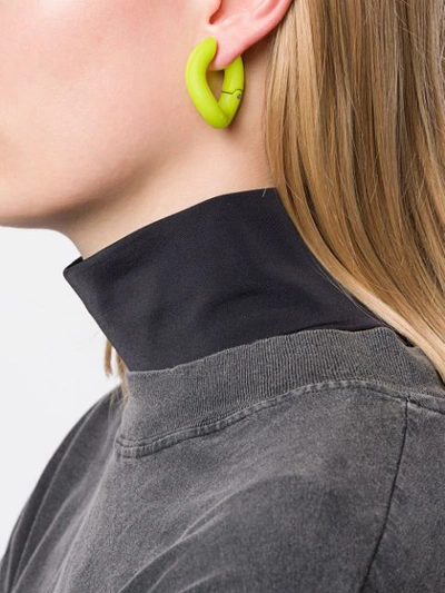 Shop Balenciaga Loop Earrings In Yellow