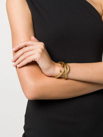 Shop Saint Laurent Monogram Textured Cuff Bracelet In Gold