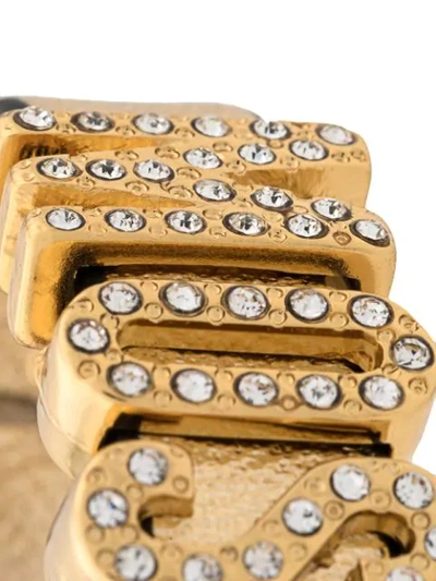 Shop Moschino Crystal-embellished Logo Bracelet In Gold