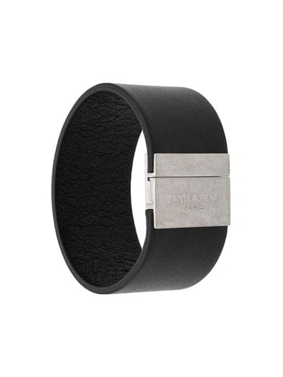 Shop Saint Laurent Embossed Logo Cuff Bracelet In Black
