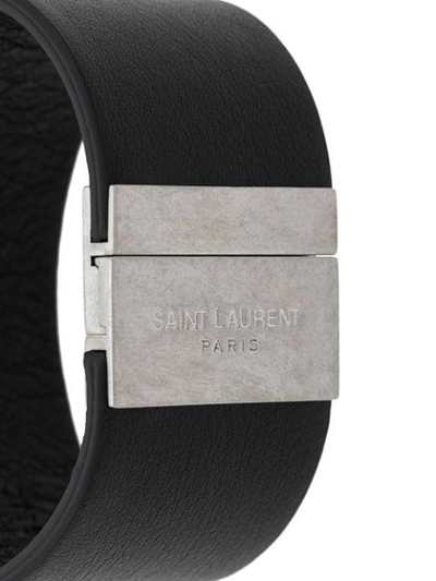 Shop Saint Laurent Embossed Logo Cuff Bracelet In Black