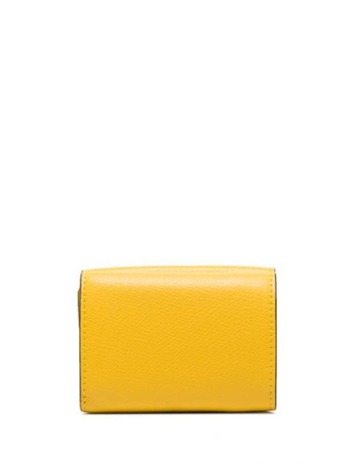 Shop Fendi Ff-embossed Trifold Wallet In Yellow