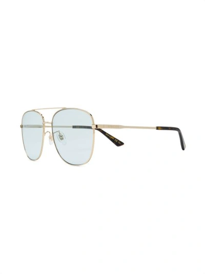 Shop Gucci Navigator Sunglasses In Gold